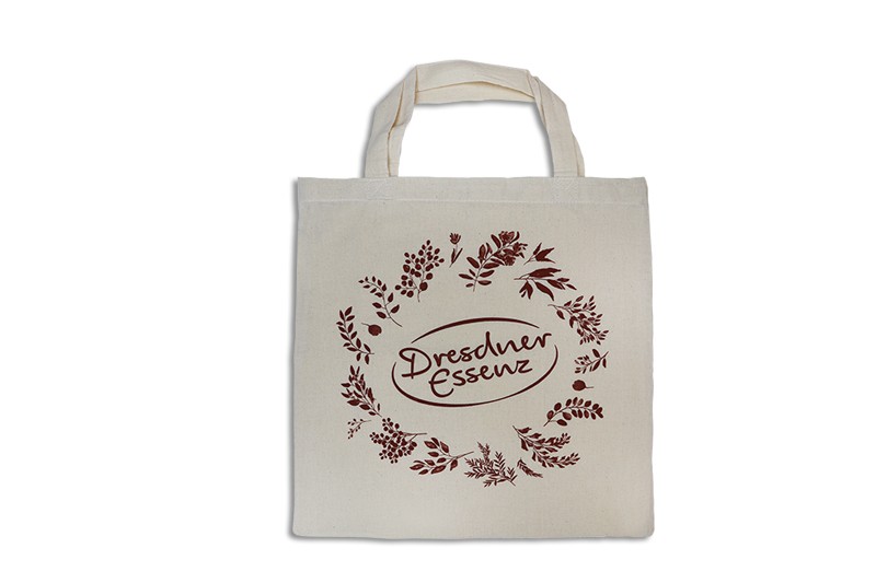 naturfarbige Baumwolltasche mit kurzen Henkeln, einfarbig braun mit Motiv Dresdner Essenz bedruckt