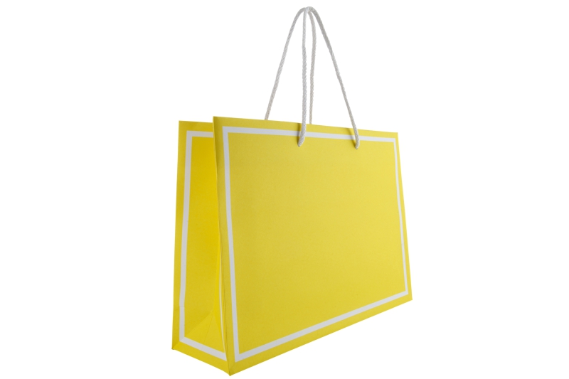 Gelbe Papiertasche Coty21 mit weißen Rahmen und Baumwollkordeln