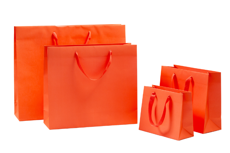 exclusive orange Papiertaschen mit Baumwollbändern in vier Größen auf der Seite von tausendtypentragetaschen